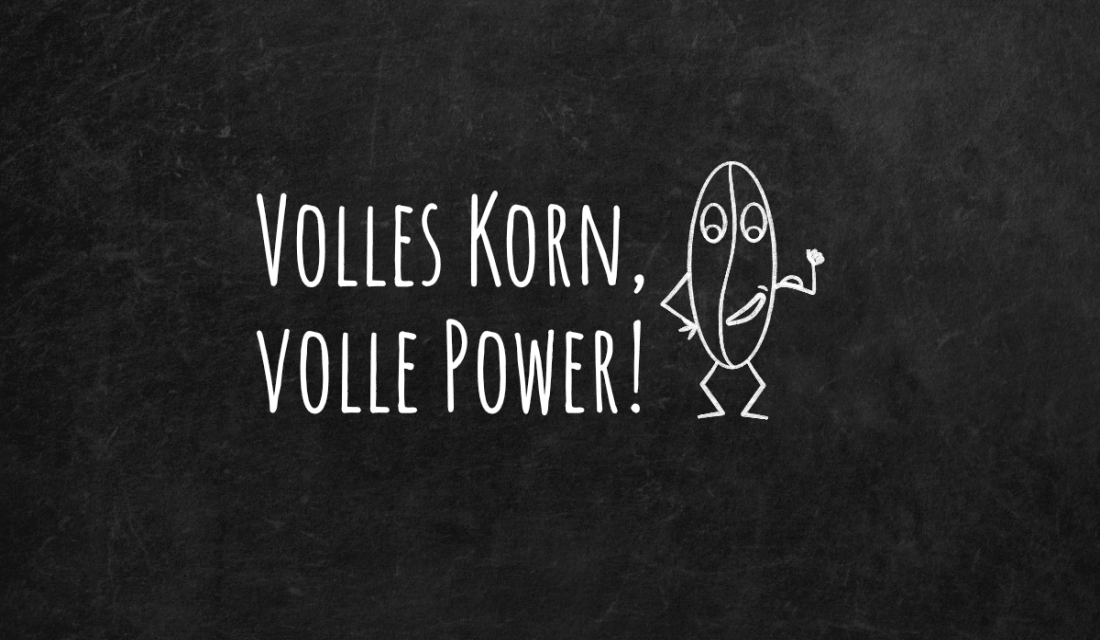 Schwarze Tafel auf der mit Kreise geschrieben ist: Volles Korn, volle Power. Daneben ist eine Comiczeichnung mit weißer Kreise von einem Getreidekorn.